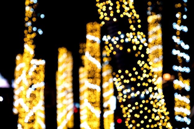 Colorful golden bokeh on pole of Christmas lights and New year