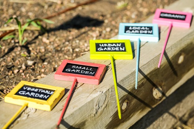 Colorful grden tags with chalk board serfices.