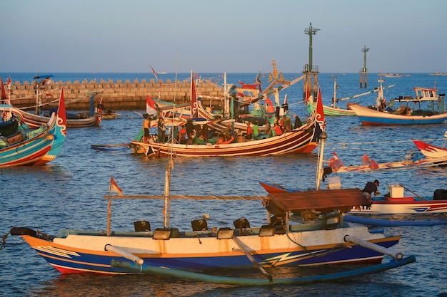 Colorful handcrafted Balinese wooden fishing boat at port in Jimbaran beach, Bali