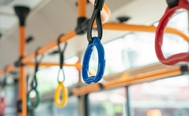 Colorful handle for standing passenger in public electric bus of college, vehicle transportation interior