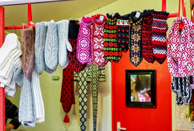 Colorful handmade mittens hanging at one of the stands during the Christmas market in Riga, Latvia. At this stall people can also warm woolen scarfs, hats and even toys.