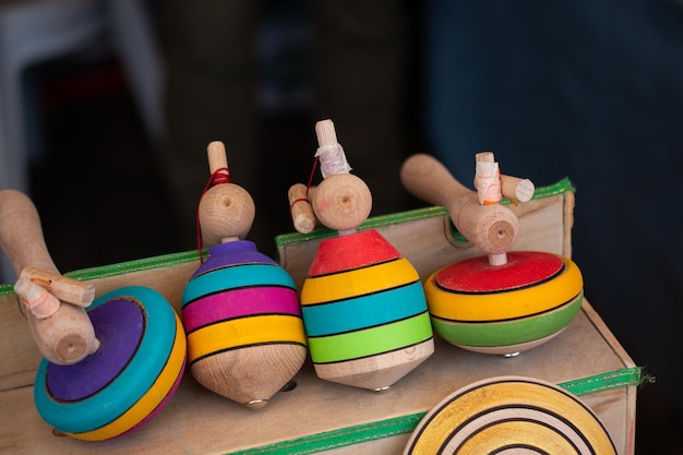 Colorful handmade painted wooden toys peg tops or whirligigs as creative background