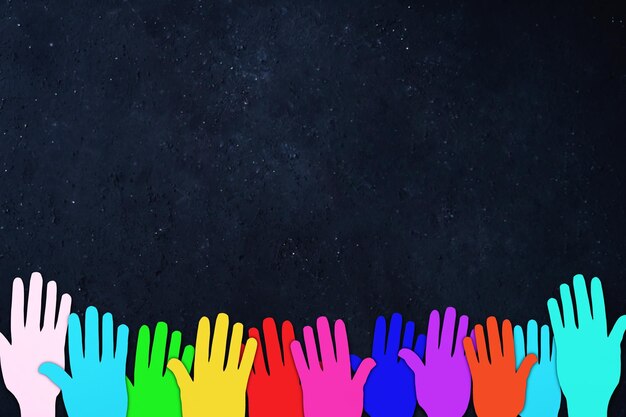 Photo colorful hands reaching the night sky full of stars