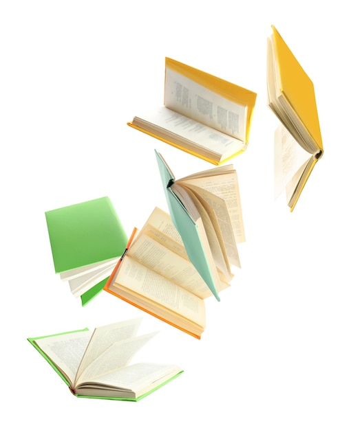 Colorful hardcover books flying on white background