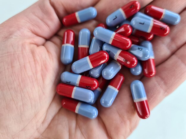 Colorful heart pills and medicines in hand