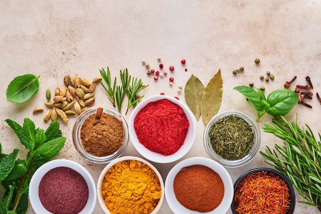 Colorful herbs and spices for cooking: turmeric, dill, paprika, cinnamon, saffron, basil and rosemary.  