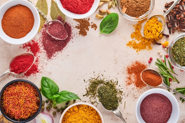 Colorful herbs and spices for cooking: turmeric, dill, paprika, cinnamon, saffron, basil and rosemary.  