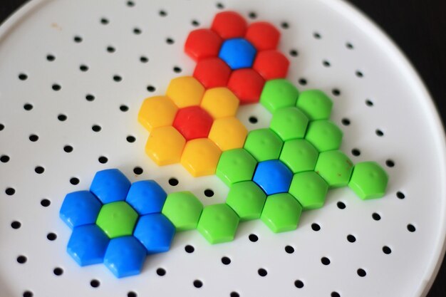 A colorful hexagon made from plastic beads.