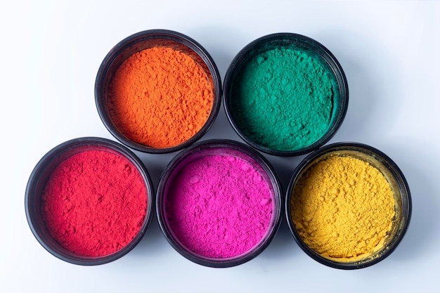 Colorful holi powder in a bowl on a white background Holi festival concept