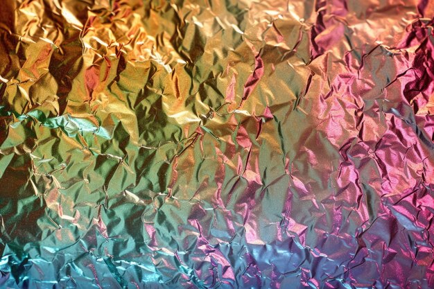 Colorful holographic foil background with iridescent rainbow texture