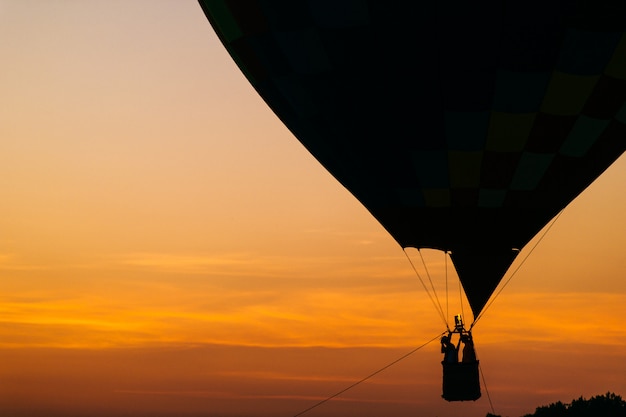 Colorful hot air balloon floating at sunset