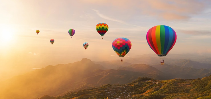Colorful hot air balloons flying above mountain at sunrise sky background Travel natural background