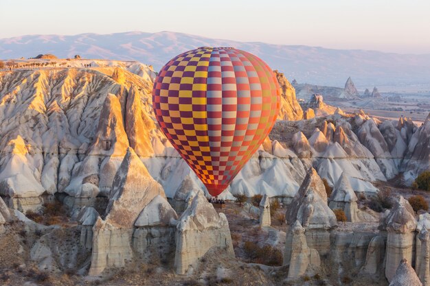 Colorful hot air balloons  in Goreme national park, Cappadocia, Turkey. Famous touristic attraction.