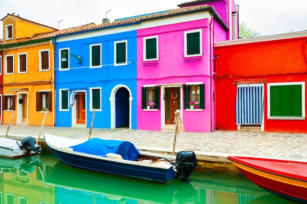 Colorful houses on the canal in Burano island, Venice, Italy. Famous travel destination.