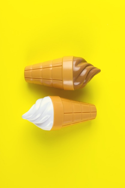 Colorful ice cream cones toy on yellow background.