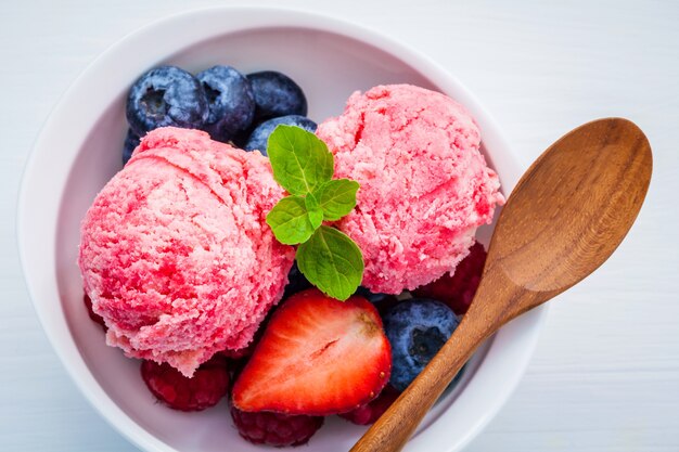 Colorful ice cream with mixed berry and various fruits setup on white background 