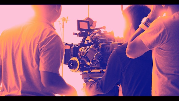 Colorful images of behind the scenes shooting production crew team and hd video camera equipment