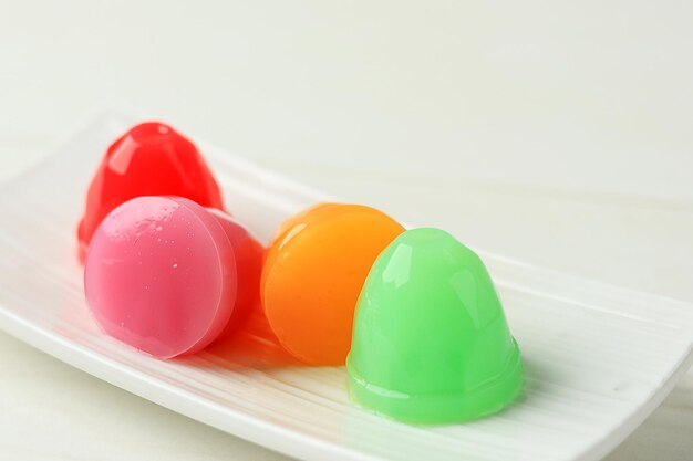 Photo colorful jelly cup on white plate