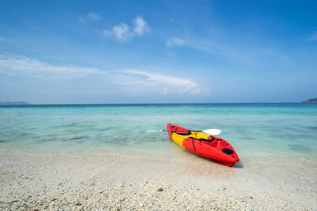 Colorful kayak on the tropical beach with blue sky