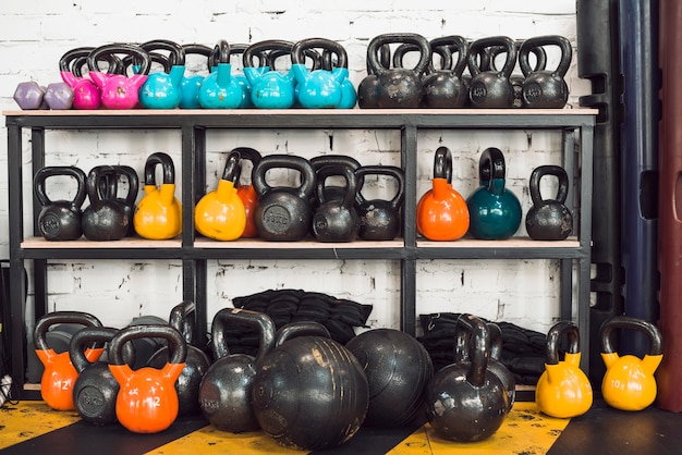 Colorful kettlebells arranged in rack