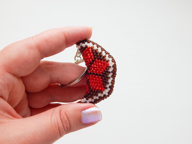 Colorful keychain lies on a woman's palm