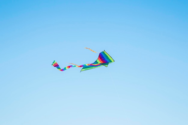 Colorful kite flying in the blue sky Summer games and fun