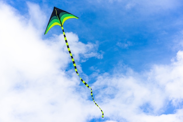 Colorful kite flying through air on sky