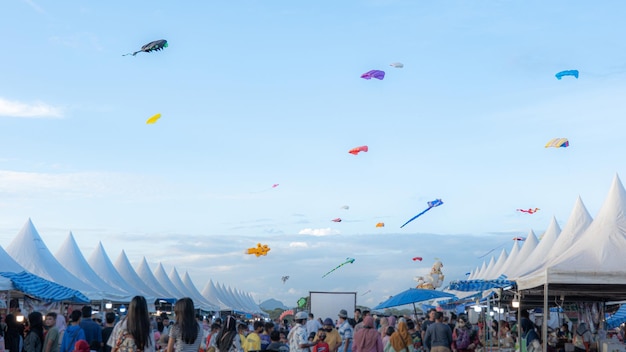 写真 風の強い天候に逆らって飛ぶカラフルな凧は、サトゥーン タイのカイト フェスティバルで青い空の中庭の前での趣味です。