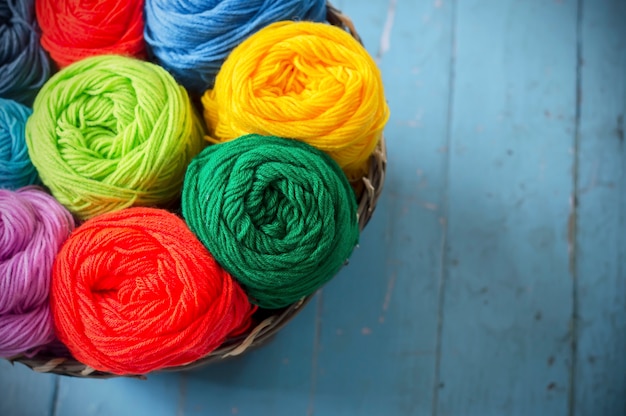 Colorful knitting in wooden basket