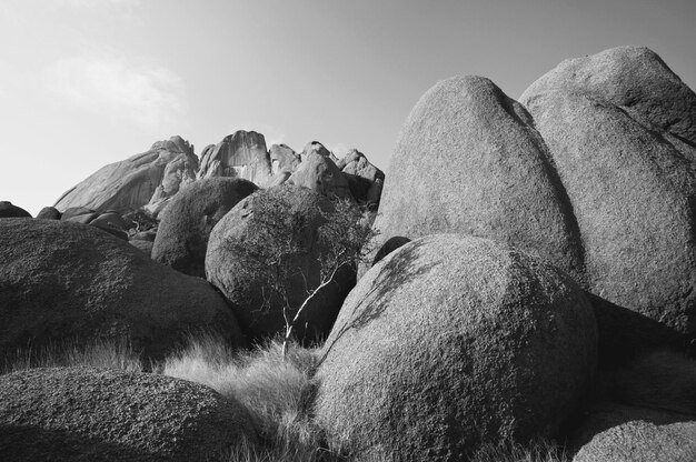 Colorful landscapes of the orange rocks in the Spitscoppe mountains in Namibia on a sunny hot day.