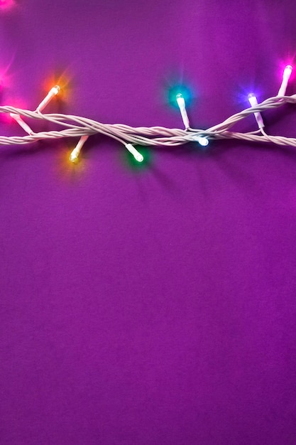 Colorful led lights decorative garland on purple background