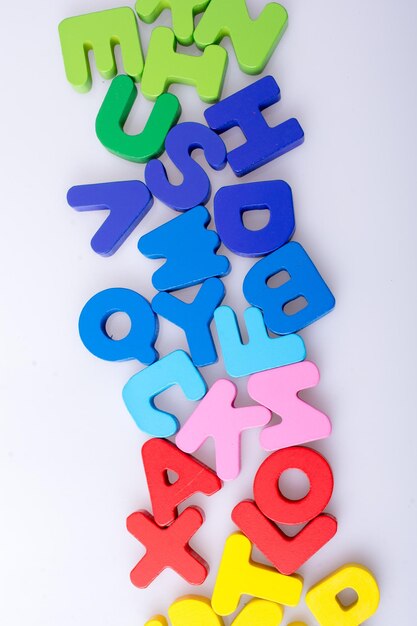 Colorful letter blocks scattered randomly on white