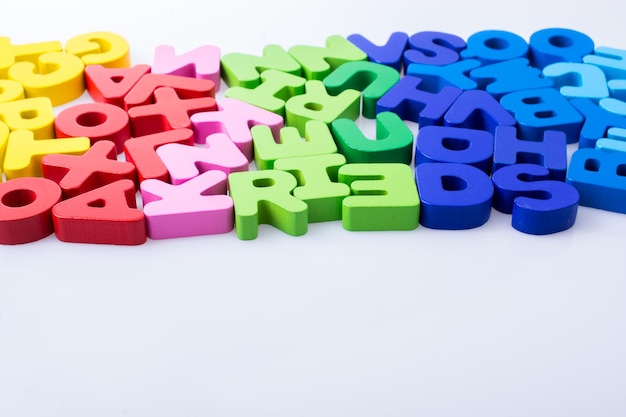 Colorful letter blocks scattered randomly on white