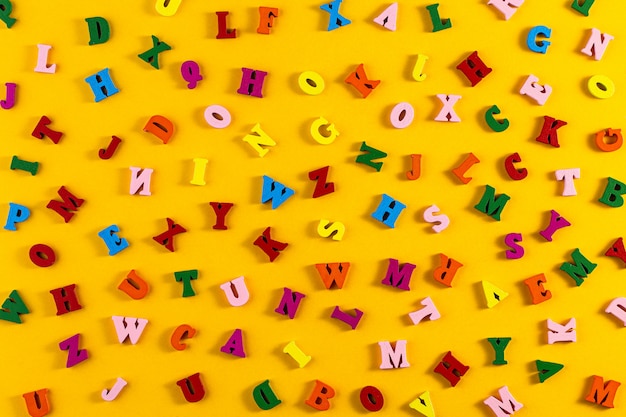 Colorful letters of the English alphabet on a yellow background.