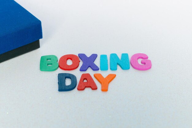 Colorful letters with the word boxing day on a white background and with glitter