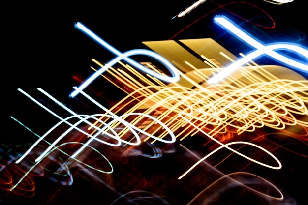 Colorful Light trails against dark background.