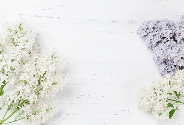 Colorful lilac flowers over wooden background Top view with space for your text