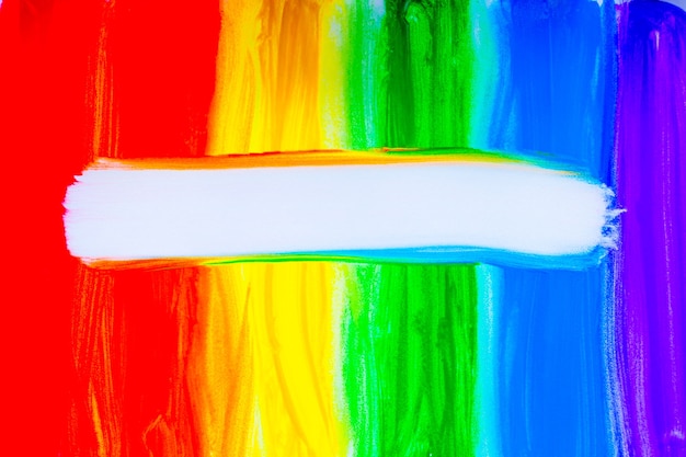 Photo colorful lines drawn vertically with paint in the form of a rainbow with a white place for text in t...