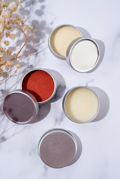 Colorful lip balms in round tin cases with shadow overlay mockup design