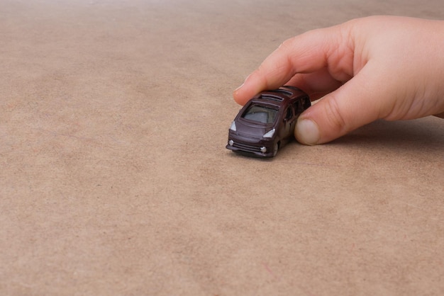 Colorful little toy car in hand