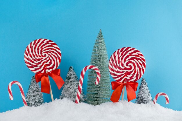 Colorful lolipop on blue background, wooden stick