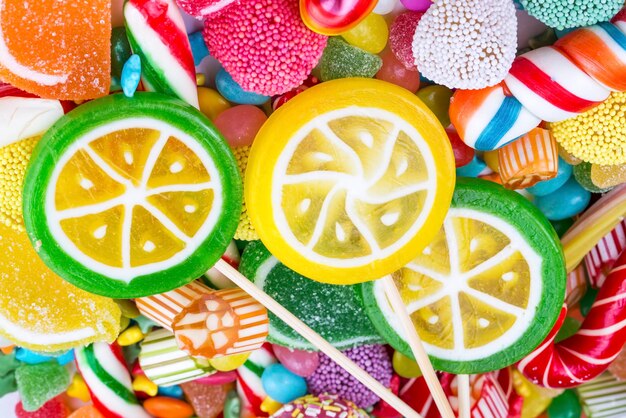 Colorful lollipops and different colored round candy. Top view.