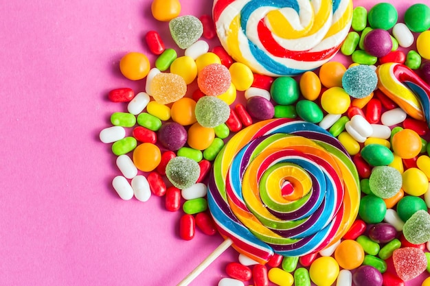 Colorful lollipops and different colored round candy. Top view.