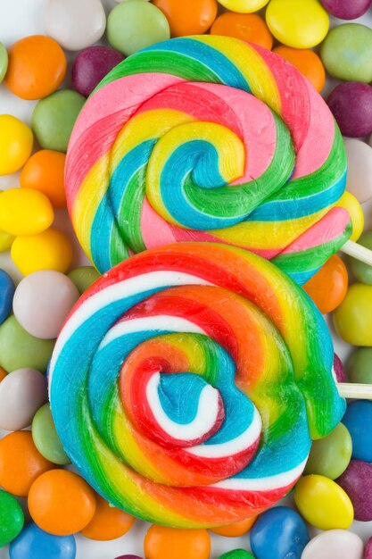 Colorful lollipops and different colored round candy. Top view.