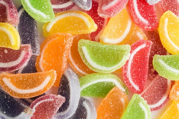 Photo colorful lollipops and different colored round candy. top view.