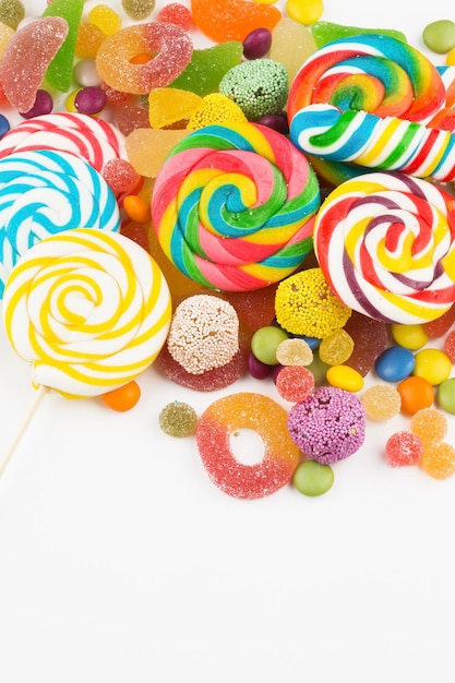 Colorful lollipops and different colored round candy. Top view.