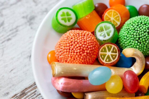 Colorful lollipops and different colorful round candy. Top view.