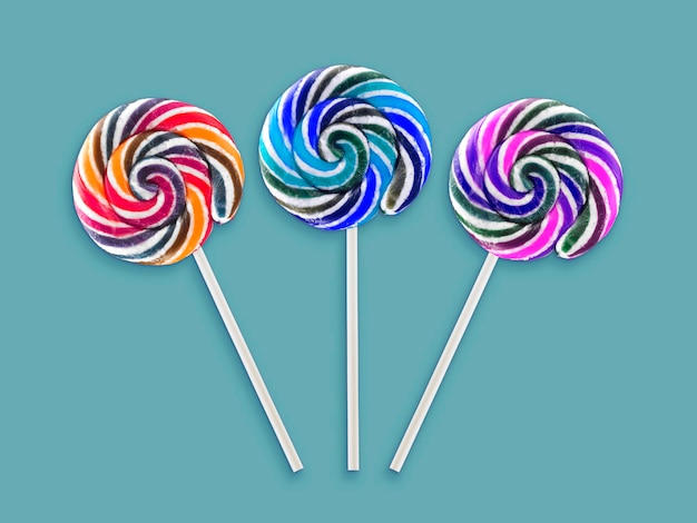 Colorful lollipops on green background
