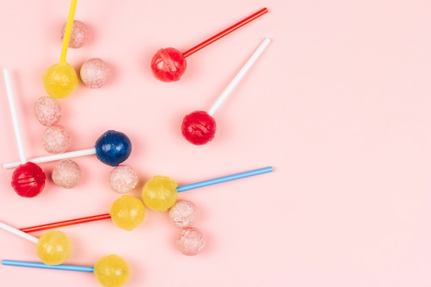 colorful lollipops on a pink background