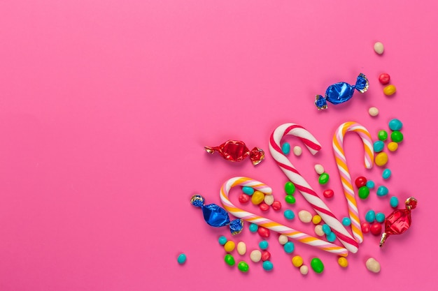 Colorful lollipops on a pink background